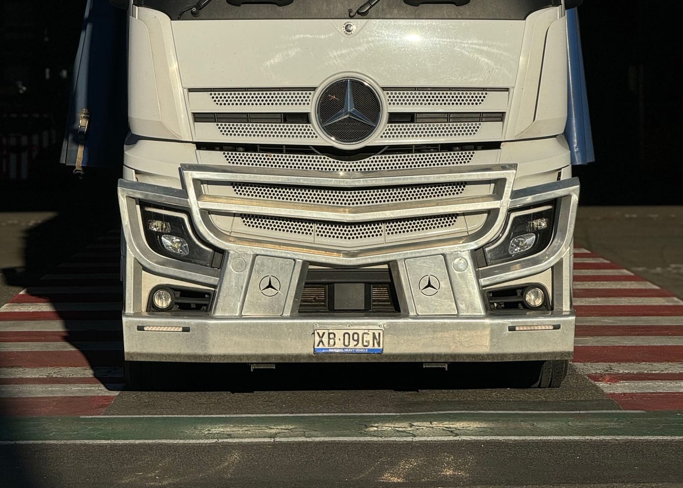 A cab-over B-double on the highway